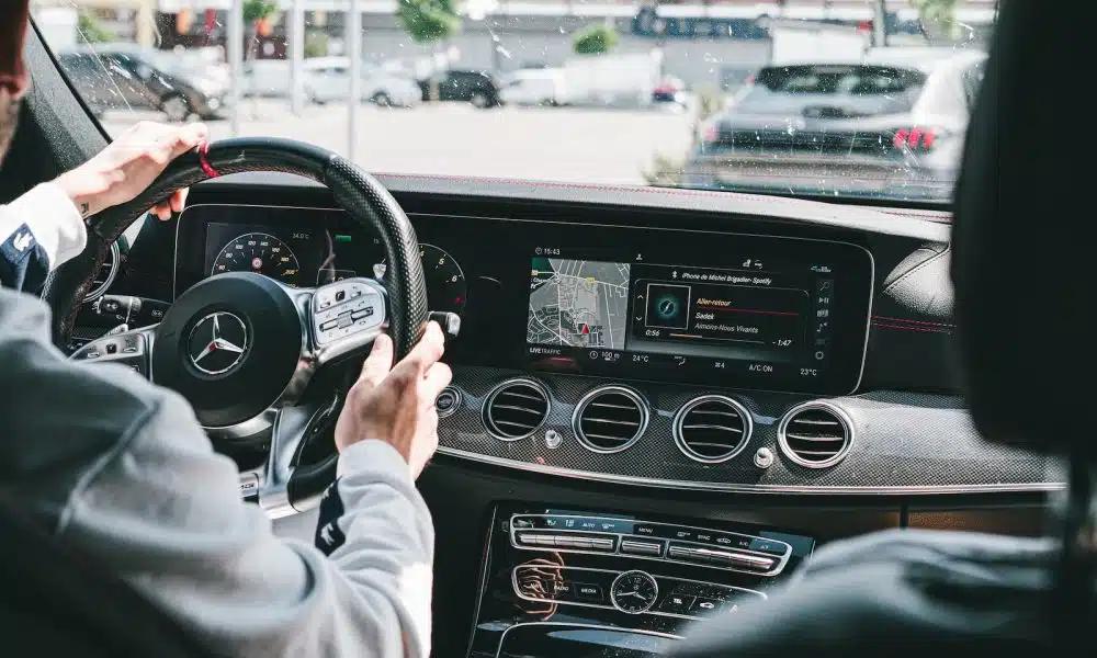 person in gray long sleeve shirt driving car