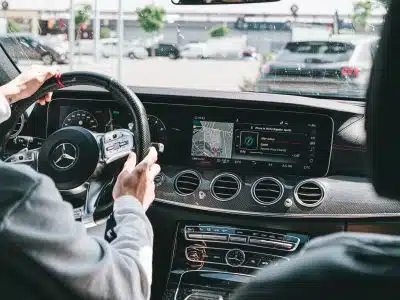 person in gray long sleeve shirt driving car