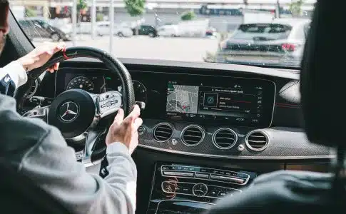 person in gray long sleeve shirt driving car